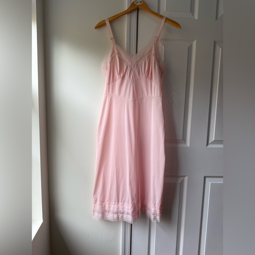 Pink 50s slip dress with lace trim, adjustable straps and a flowy fit dress.